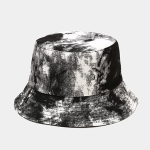 Close-up of black and white tie-dye ink texture on a wide brim bucket hat canvas