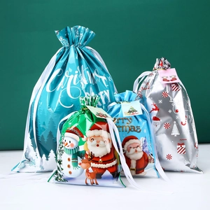 Set of four plastic Christmas drawstring gift bags with tags and festive patterns