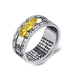 Detailed view of silver ring with golden PiXiu relief and Buddhist sutra engravings