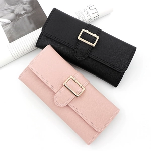 Close-up of black and pink long wallets with lychee pattern leather and gold metal buckles