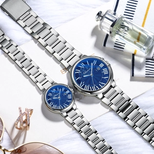 Macro detail of silver steel watch bands and blue sunray dials with roman numerals