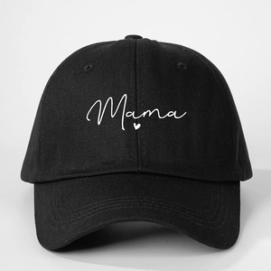 Close-up of black baseball cap with white Mama script and small heart embroidery