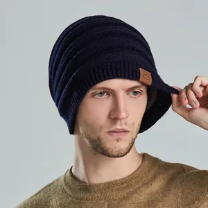 Unisex navy blue ribbed knit beanie with brown leather patch and warm fleece lining