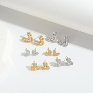 Minimalist gold and silver heart stud earrings set with sparkling zircon stones