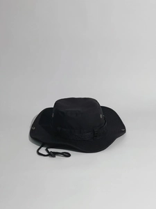 Close-up of black outdoor sun hat featuring metal vents and adjustable wind cord