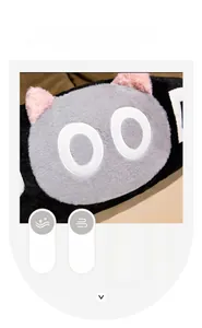 Close-up of soft rabbit fur texture and 3D ears on a gray plush cat pillow