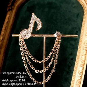 Elegant gold musical note brooch with rhinestone accents and triple layer tassel chain
