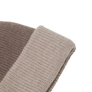 Macro shot of ribbed knit beanie featuring thick brown and beige two-tone contrast stitching