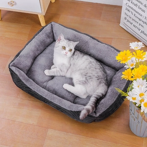 Cosy white cat resting in a thick grey flannel pet blanket on a wooden floor