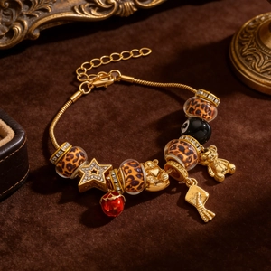 Detail of leopard print beads and gold bear pendants on a vintage charm bracelet