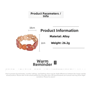 Detail view of gold-tone geometric bracelet with orange enamel patterns, size 18cm x 2cm