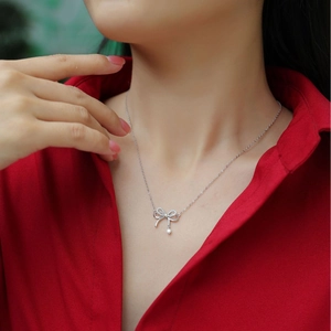 Sparkling S925 sterling silver bowknot necklace with tassels on a female model
