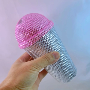 Close-up of pink and silver rhinestones on a microphone shaped insulated tumbler cup