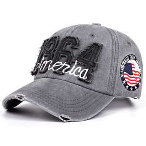Close-up of vintage washed denim hat with 1964 America embroidery and distressed details