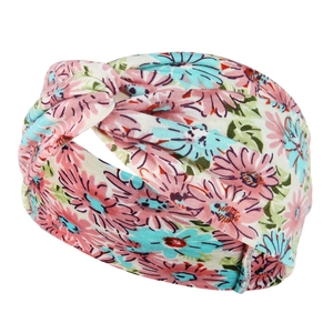 Detail of twisted beige yoga headband with pink and blue floral patterns on soft elastic fabric