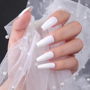 Glossy solid white coffin ballet press-on nails on hand with elegant lace background