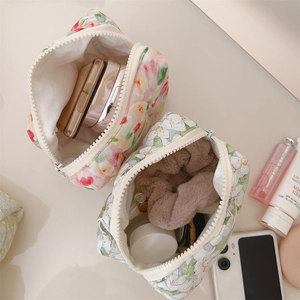 Detailed internal capacity of quilted floral cotton makeup bag with zip closure