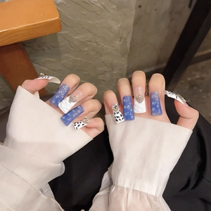 Handmade Y2K blue duckbill nails with 3D pearls, silver crosses, and cow print patterns