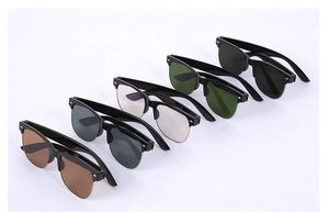 Detail of five semi-rimless sunglasses in gray, green, clear, light gray and brown lenses