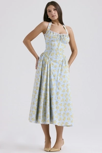 Detail of the halter neckline featuring white lace trim and floral print on light blue dress