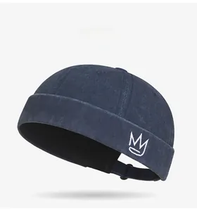 Detail view of navy blue docker hat featuring crown embroidery and premium canvas texture