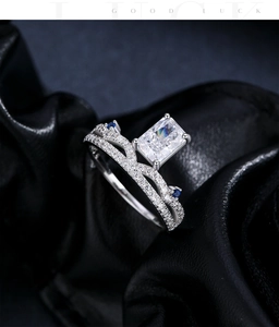 Macro shot of silver ring with radiant cut rectangle stone and blue accent gems