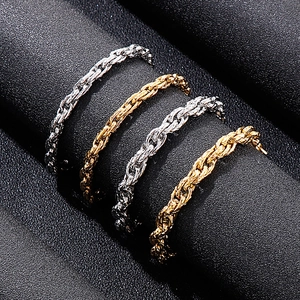 Detail of hip-hop snake twist chain necklaces in silver and gold on black background