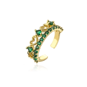 Macro shot of 18K gold-plated adjustable ring with green zircons and hollow heart patterns