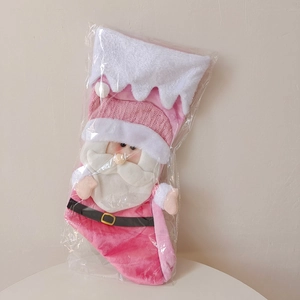 Detailed view of pink plush Santa Claus Christmas stocking in transparent packaging