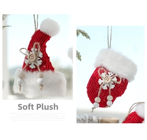 Detail of red knit Christmas hat and glove with white faux fur and wood button decor