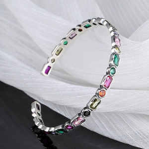 Vintage silver open bangle with geometric rainbow zircons in various colors and shapes