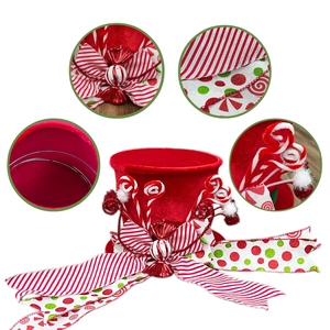 Christmas tree topper hat with red velvet finish, festive ribbons and candy decorations