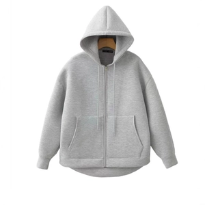 Gray oversized zip-up hoodie with drop shoulders and kangaroo pockets on a wooden hanger
