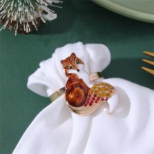 Close-up of enamel fox napkin ring with colorful rhinestones on a white festive napkin