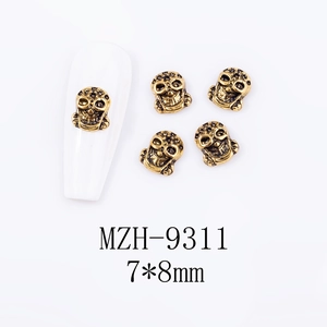 Detailed close-up of 5-piece retro gold skull nail art charms measuring 7x8mm for DIY
