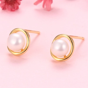 Elegant 925 silver pearl stud earrings with golden circular hollow frame on pink background