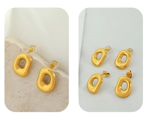 Detailed view of irregular oval gold earrings on natural stone and white fabric