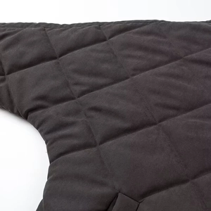 Detailed macro view of dark grey quilted fabric with diamond pattern and soft padding