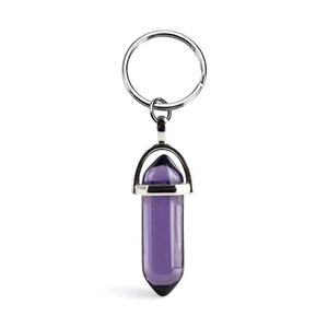 Natural purple hexagonal crystal pendant keychain with silver metal ring on white background