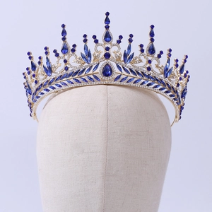Detailed view of luxury gold bridal crown with deep blue crystals and clear rhinestones