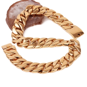 Mens thick gold plated Cuban link necklace on natural stone display, cast titanium steel