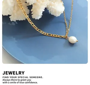 Close-up of double-layer gold chain necklace featuring a white freshwater pearl pendant