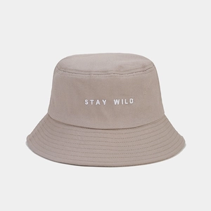Détail de la broderie Stay Wild sur bob en coton kaki avec coutures blanches apparentes