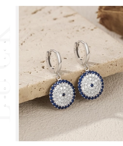 Macro shot of S925 sterling silver evil eye earrings with blue and white zircon stones
