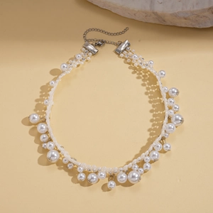 Close-up of vintage Baroque necklace featuring lustrous imitation pearls and silver clasp