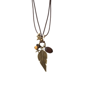 Bohemian long feather necklace with bronze leaf and wooden beads on white background