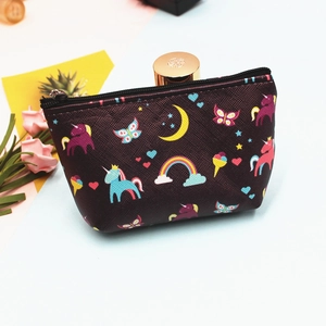 Detail of a purple unicorn coin purse showing colorful rainbow prints and a smooth black zipper