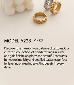 Detailed view of gold and silver textured gear rings on a magazine with a candle