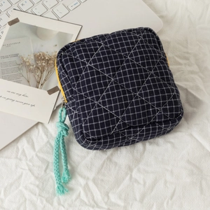 Quilted navy blue checkered cosmetic bag with yellow zipper and teal pull cord