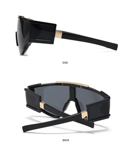 Detail view of oversized black futuristic sunglasses with side and back metal accents